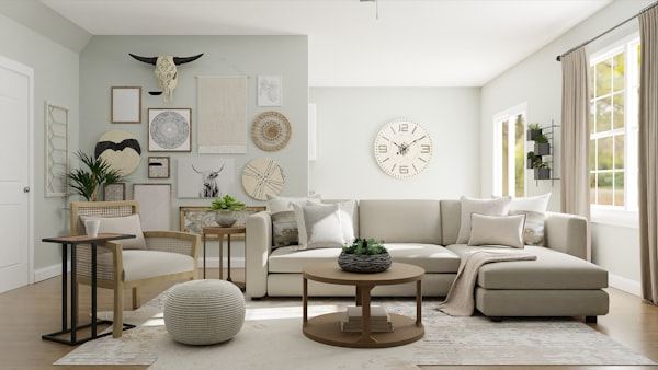 Renovated living room with pale walls, wooden floor, grey corner sofa and round coffee table